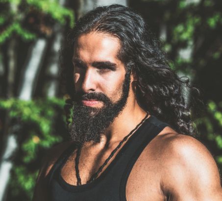 Handome bearded man with long dark hair and healthy beard