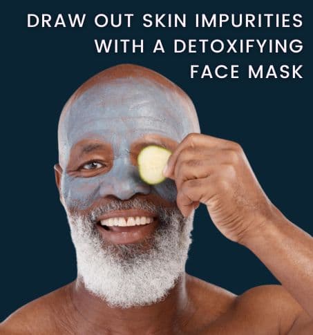 a happy mature man with a detoxifying face mask