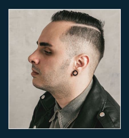 a man with a pronounced combover with center parting and undercut