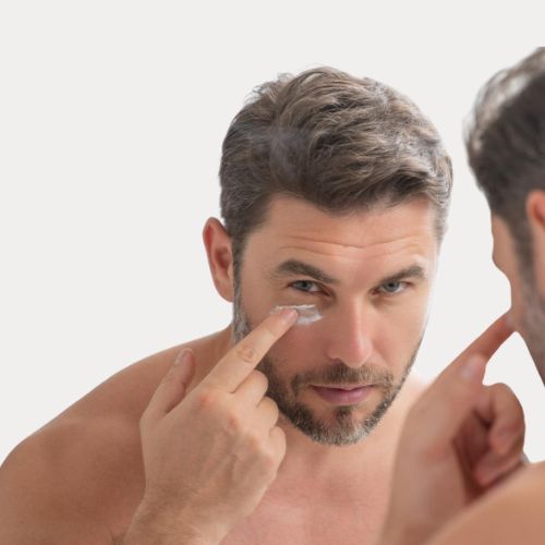 mature man applying eye cream