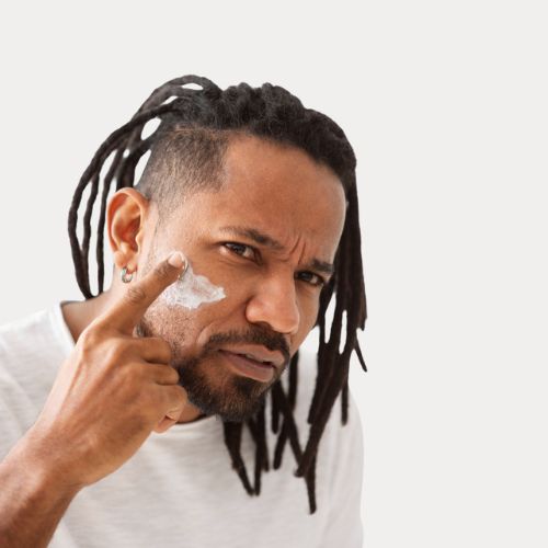mature man applying face cream