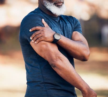 Powerful, muscular bearded man applying pressure to his arm - testosterone test
