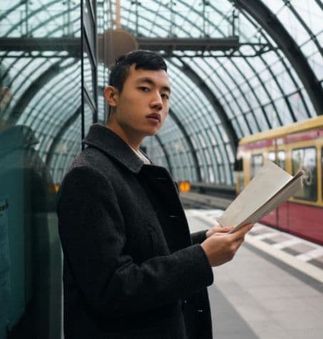 young man waiting at a train station