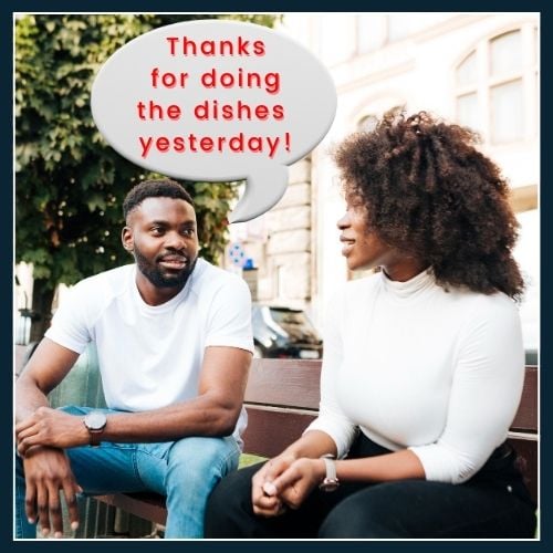 an African couple facing each other on a plain background. Above the man's there is a speech bubble with a short, specific appreciation, “Thanks for doing the dishes yesterday!”.