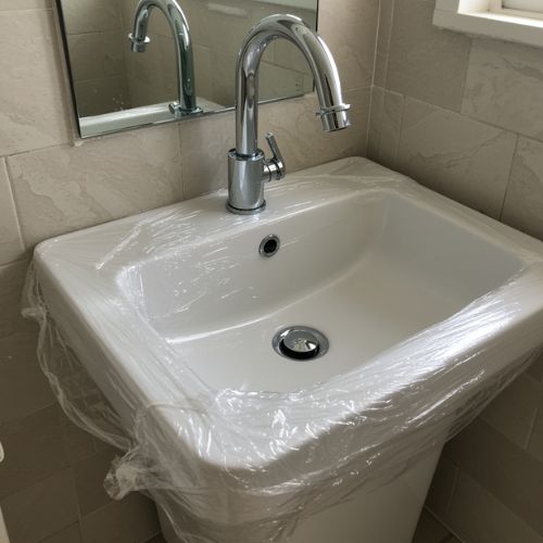 protect your space, bathroom sink covered in protective plastic wrap