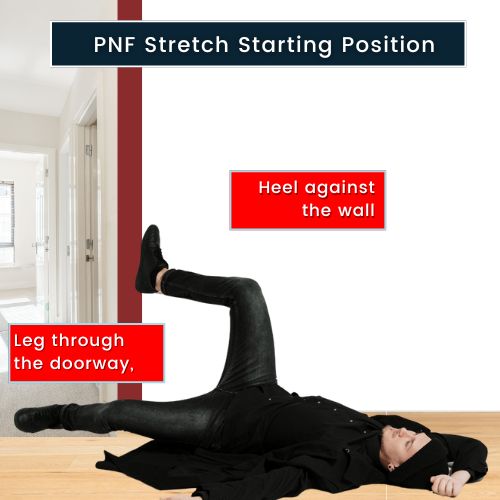 A man lying horizontally on his back, near an open door. His right leg is extended fully through the doorframe, touching the floor in the next room. His left leg is raised at about a 15–20-degree bend, resting against the doorframe. The doorframe is clearly visible on his right side.