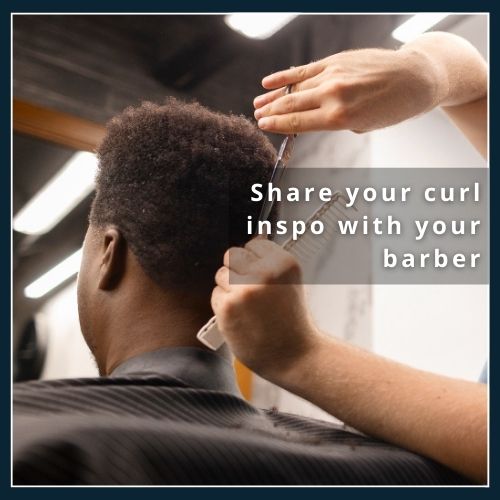 Close-up of a hairstylist trimming dry curly hair with scissors, illustrating how regular dry cuts maintain curl shape and freshness.