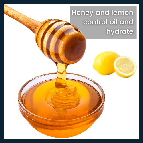 Flat-lay of a bowl of honey with a dipper and fresh lemon wedges, illustrating a DIY honey and lemon mask for oily or acne-prone skin.