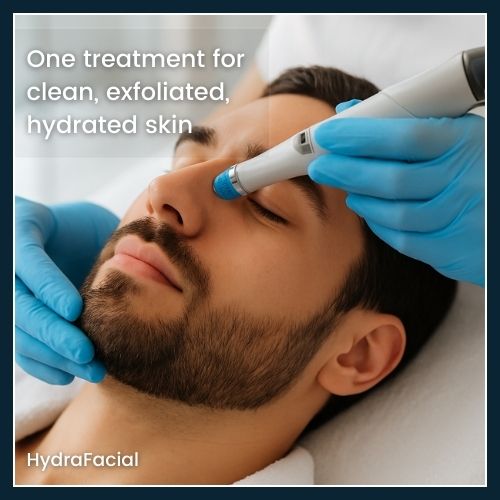Man receiving a HydraFacial with the vacuum wand applying serum to their cheek, illustrating deep cleansing, gentle exfoliation, and instant hydration.