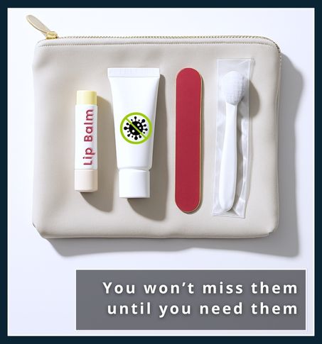 Flat-lay of lip balm, antiseptic cream, nail file, and disposable toothbrush