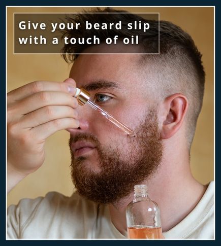 man applying beard oil to a thick curly beard
