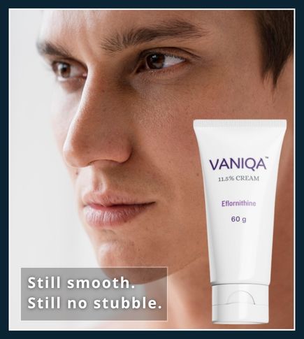 Man looking at his chin in front of a mirror after using Vaniqa to slow facial hair regrowth