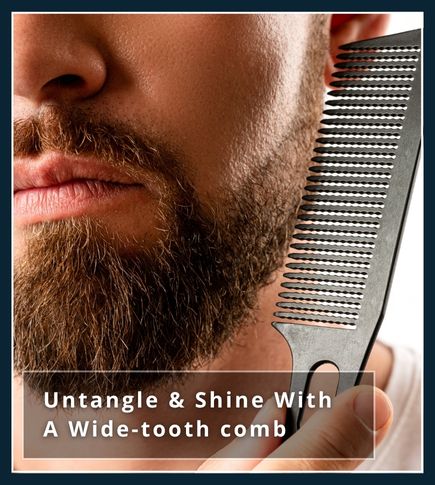 Man with a full, long beard using a wide-tooth wooden comb to detangle knots