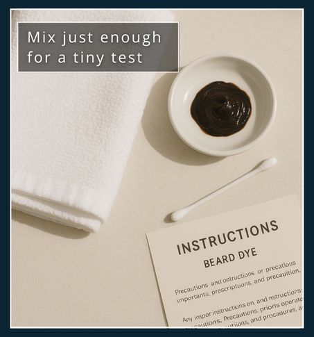 A cotton bud and small dish of mixed beard dye resting on a white towel with instructions nearby.
