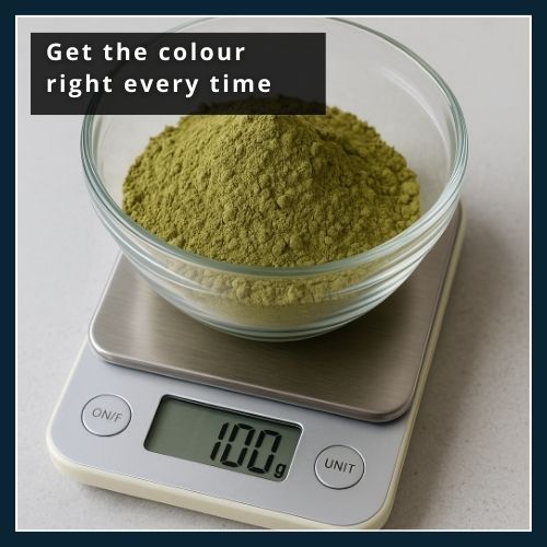 Small kitchen scales measuring out henna powder in a glass bowl for consistent beard dye colour