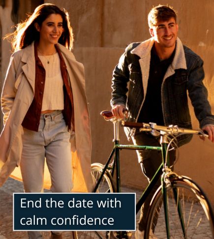 A man and woman walking side by side on a softly lit evening street outside a restaurant.