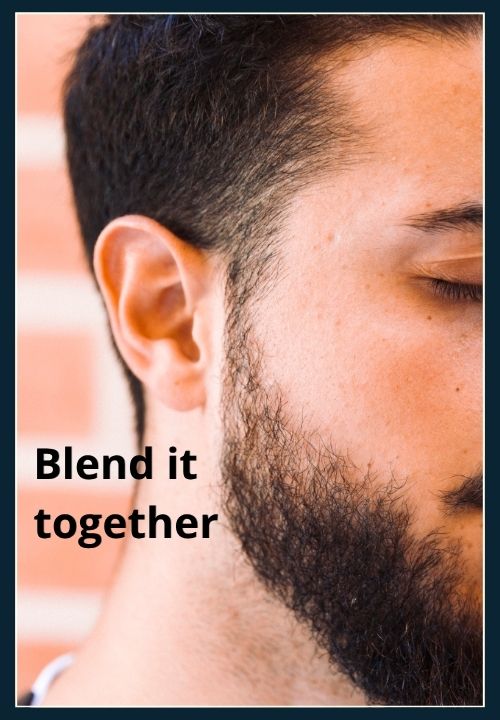 a guy with short faded sides, his beard blends into the fade. There is no harsh break between beard and hair.
