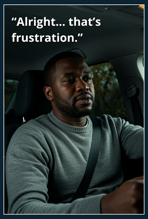 man sitting in a stationary car, he is naming his feelings as frustration.