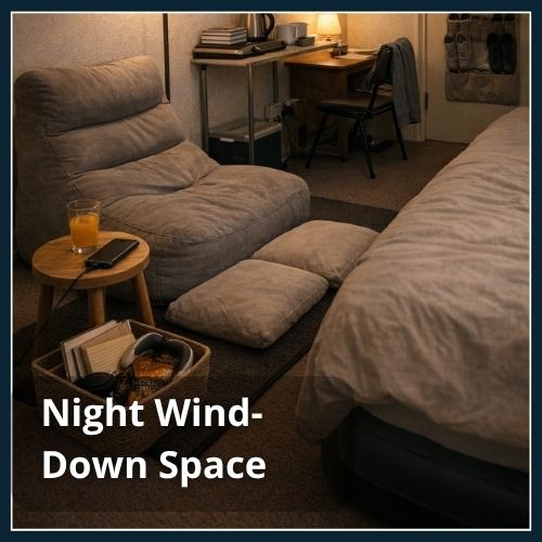 A cosy wind-down space for a man in a small bedroom. Includes bean bag, cushions and wind-down items in a basket.