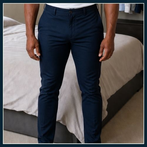 Waist to ankle shot of man wearing deep navy trousers. THe trousers are pulling around the crotch and thighs even though the waistband of the trousers sits exactly as it should.