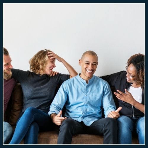 group of friends reacting to each other instead of focusing on the camera.
